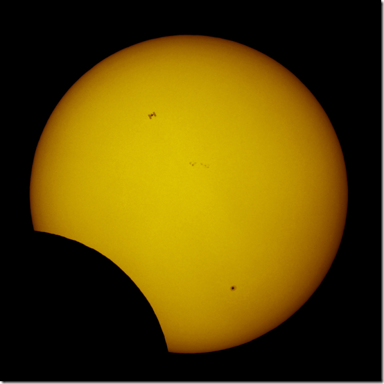 Photo of International Space Station as it Passes Across the Sun During Partial Solar Eclipse | Thierry Legault